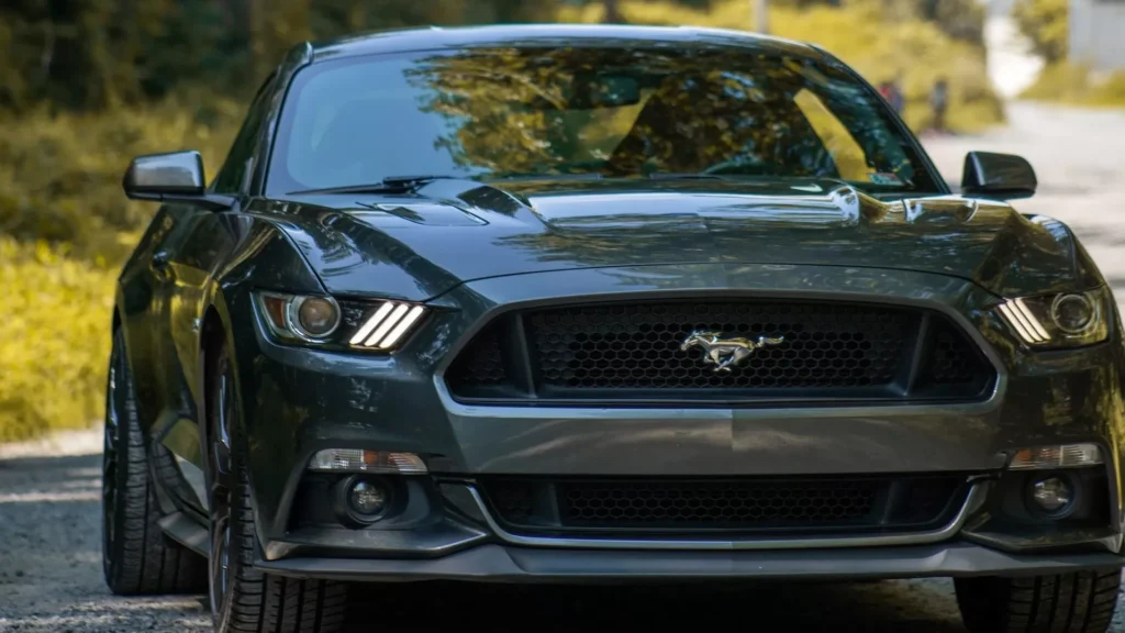 Black Mustang GT on road during daytime