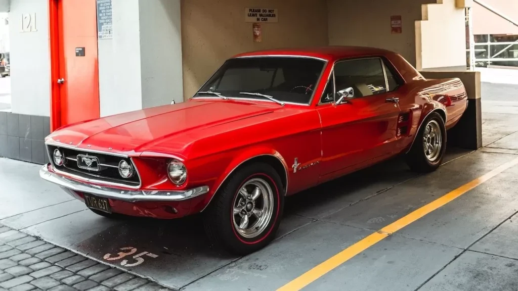 Classic red Mustang parked in an urban garage with elegant design details