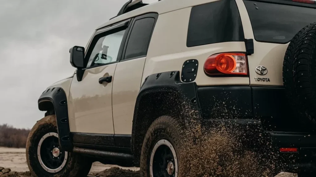 a muddy off-road trail under cloudy skies, showcasing adventure and rugged vehicle performance