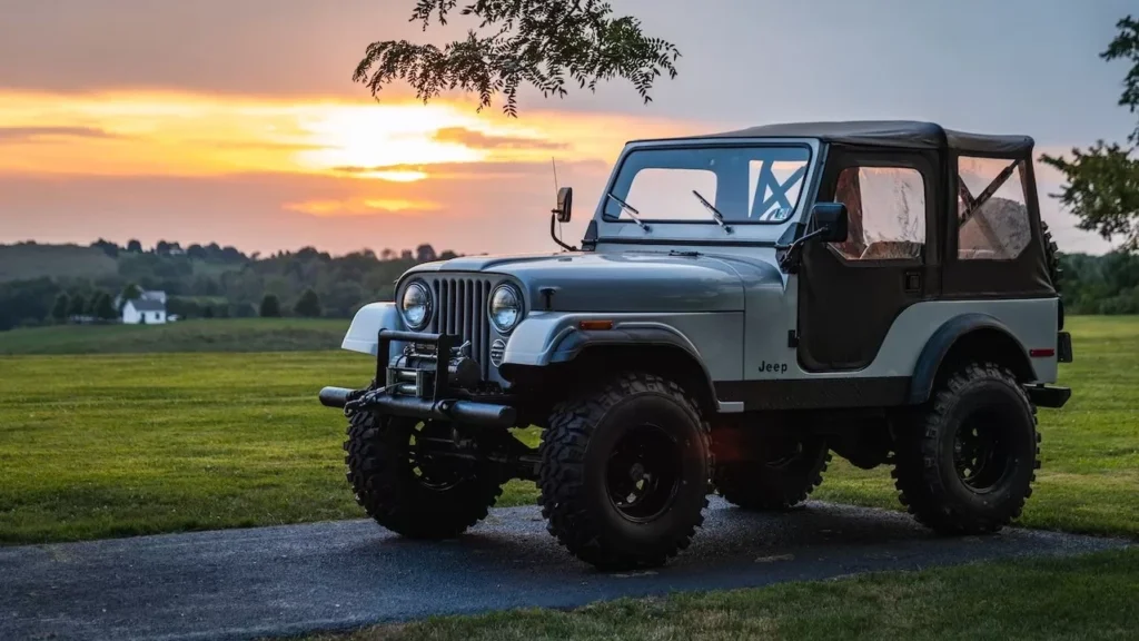 A classic Jeep parked on a rural road at sunset, showcasing a peaceful countryside scene