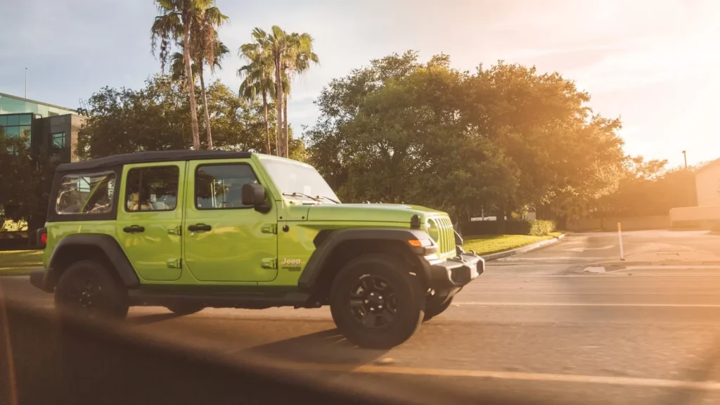 Green crew cab pickup truck on road during daytime