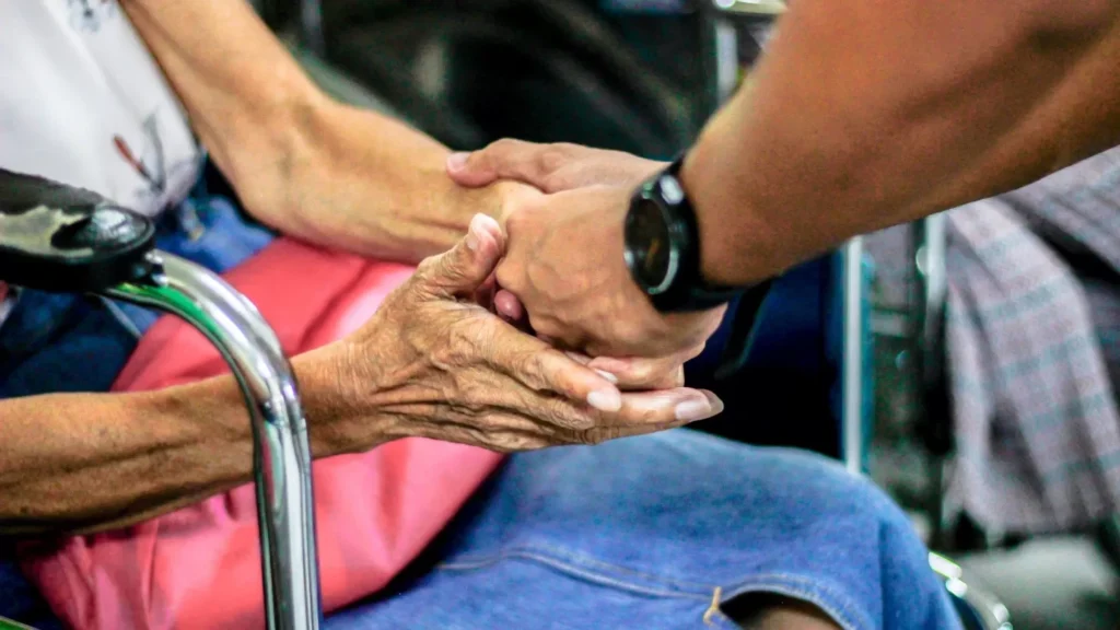 Man holding hand with woman on chair