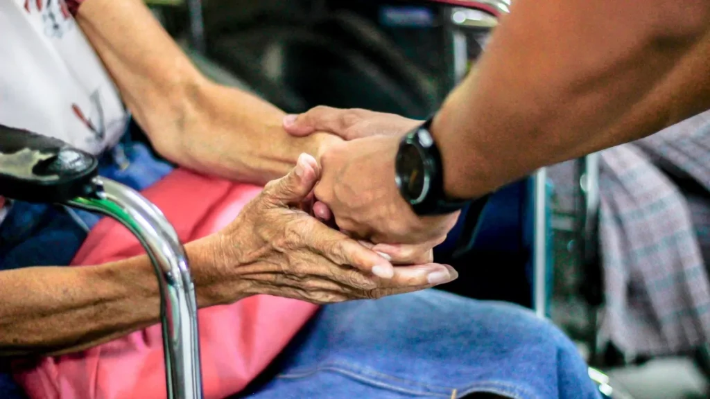 Man holding hand with woman on chair