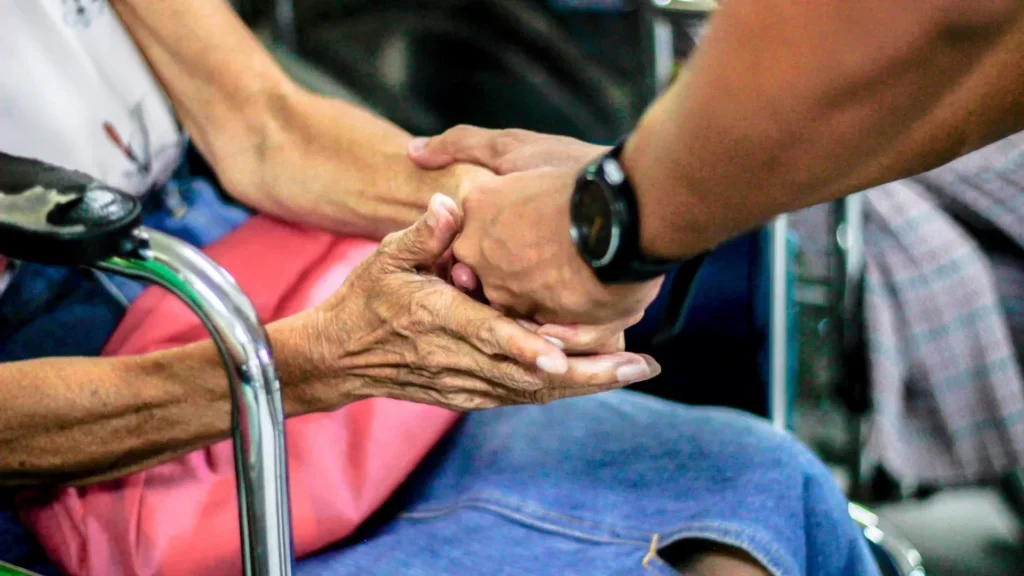 Man holding hand with woman on chair