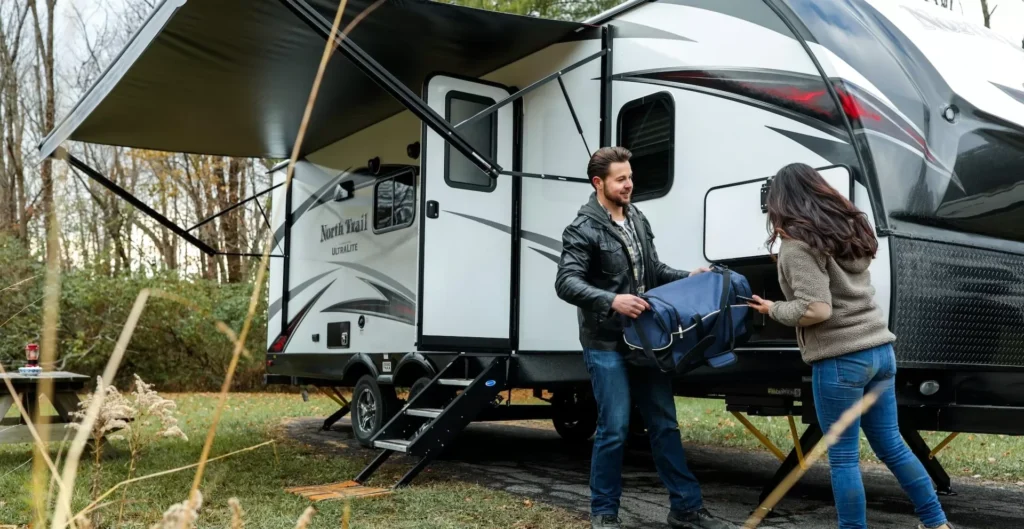 A man in black jacket unpacking camping bag