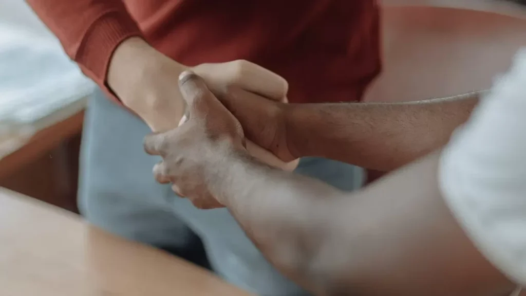 Close-up of two businessmen shaking hands, symbolizing partnership and teamwork