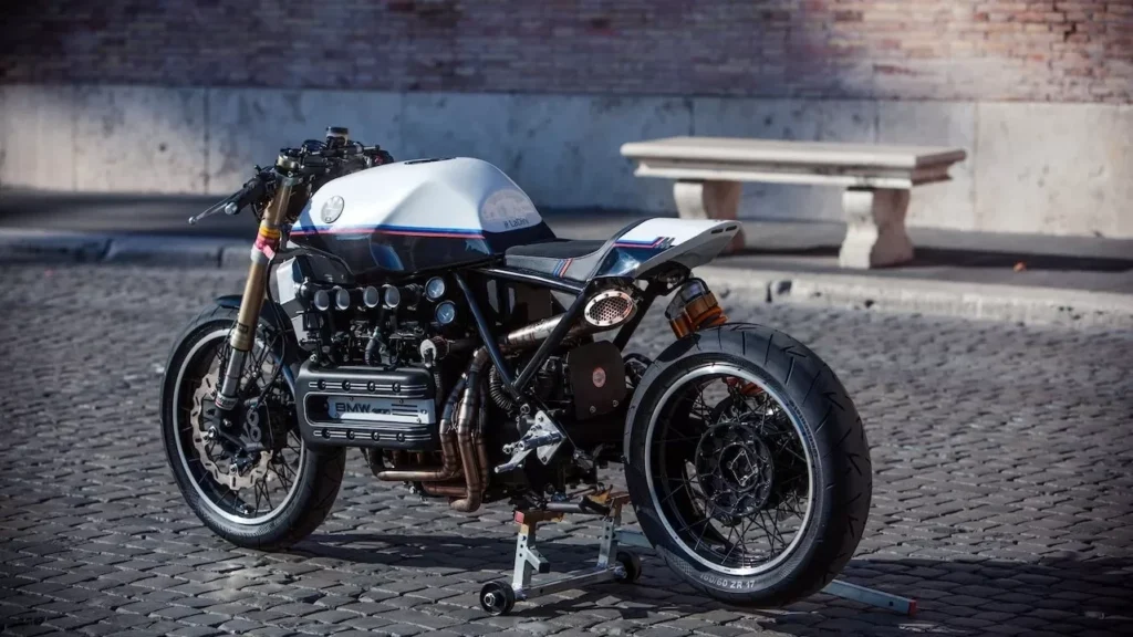 Classic vintage cafe racer motorcycle parked on cobblestone street, Rome, Italy