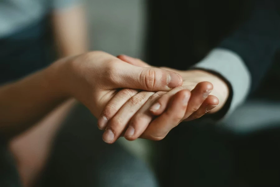 person holding baby's hand
