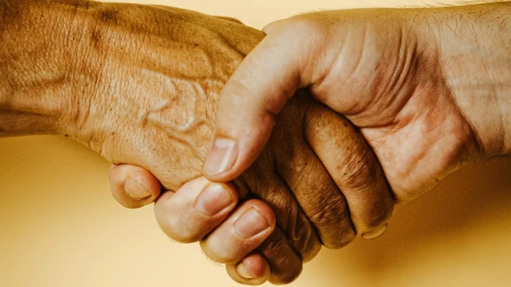 Person holding babys hand