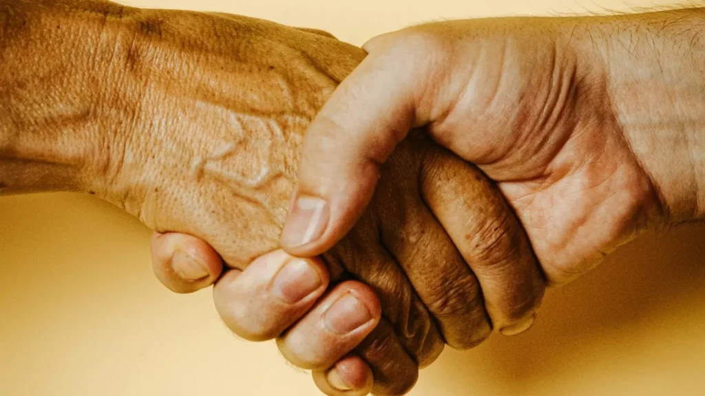 Person holding babys hand