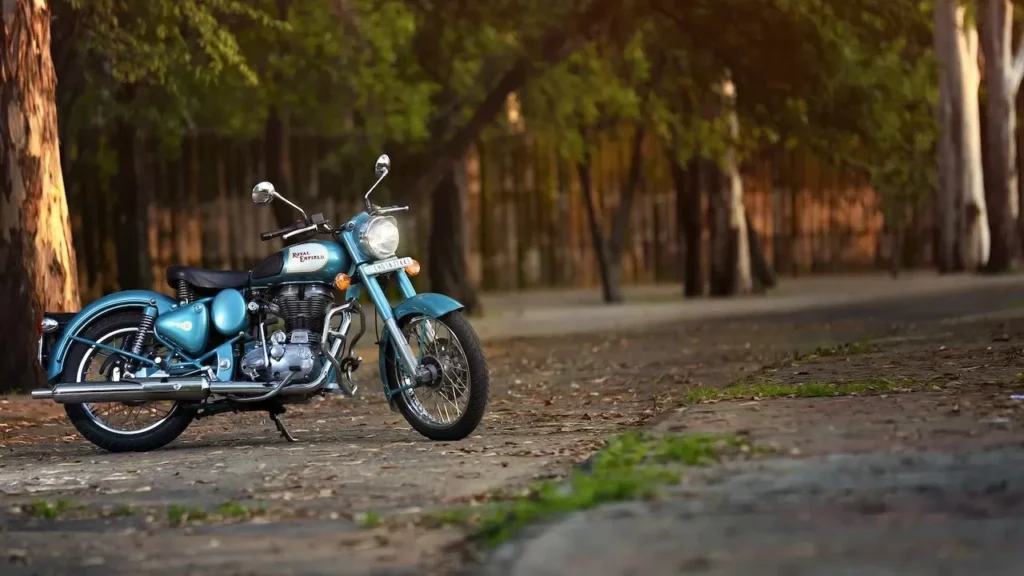 Stylish vintage motorcycle parked under a tree in a serene outdoor setting