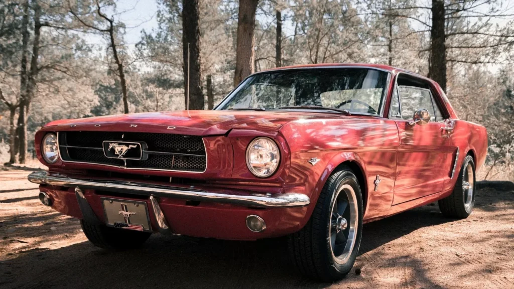 Pink Ford Mustang in a forest environment