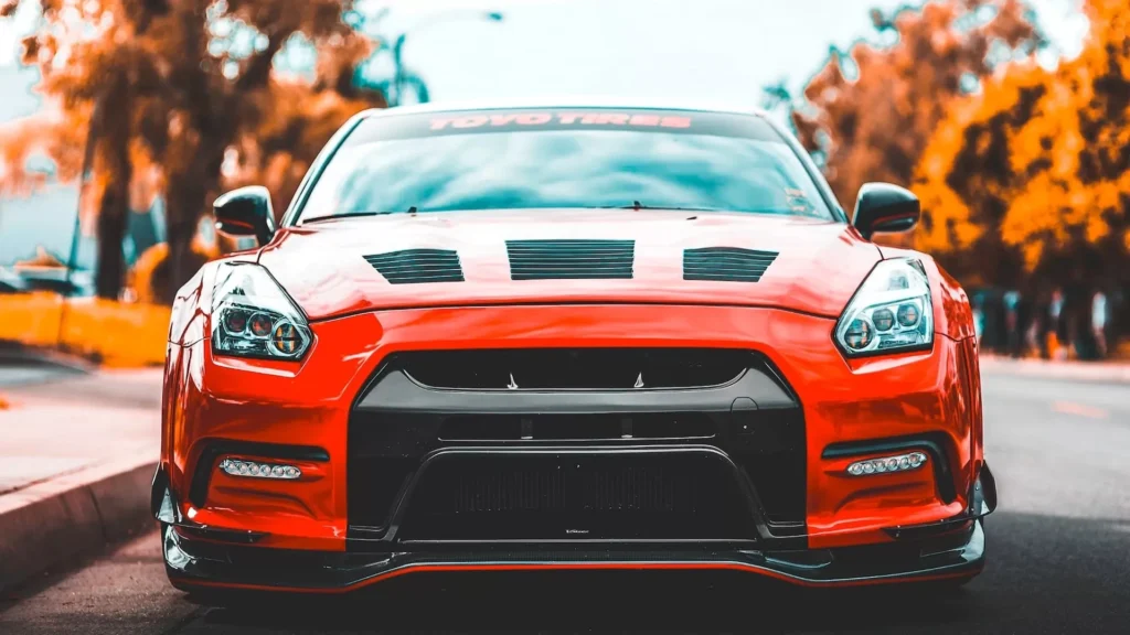 Red car near trees