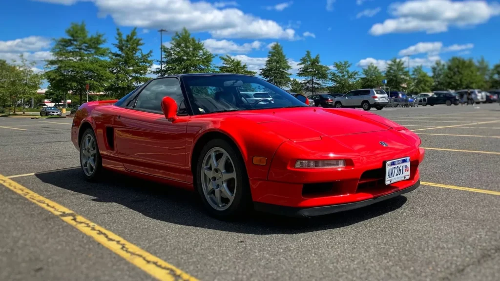 Red Honda NSX on road during daytime
