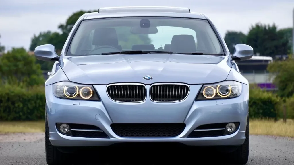 A modern blue sedan car parked on a rural road, showcasing its luxury and design