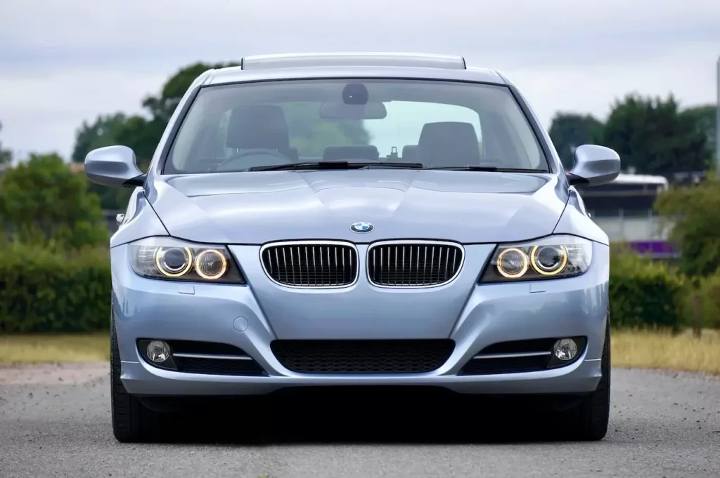 modern blue sedan car parked on a rural road, showcasing its luxury and design.