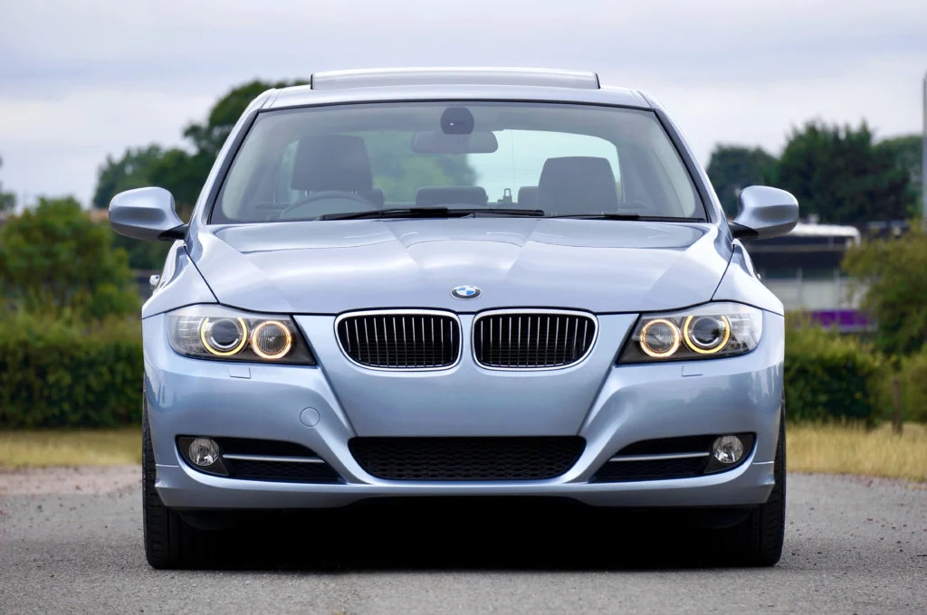 A modern blue sedan car parked on a rural road, showcasing its luxury and design