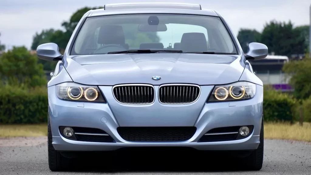 A modern blue sedan car parked on a rural road, showcasing its luxury and design