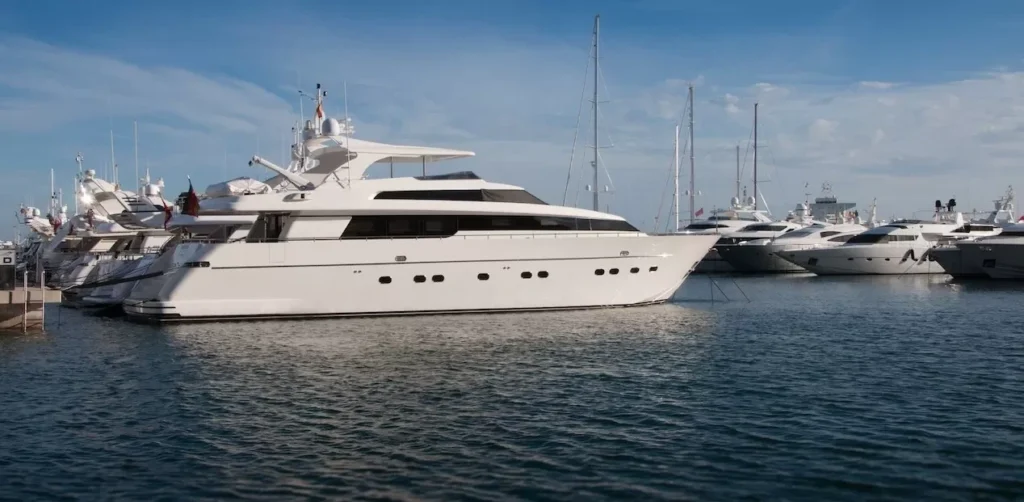 A serene marina scene featuring luxury yachts docked under a clear blue sky