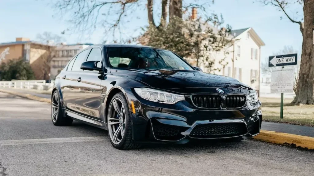Black BMW parked on a road