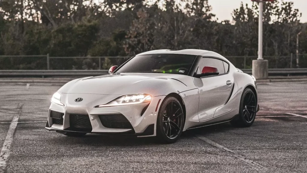 White sports car parked on an empty parking lot