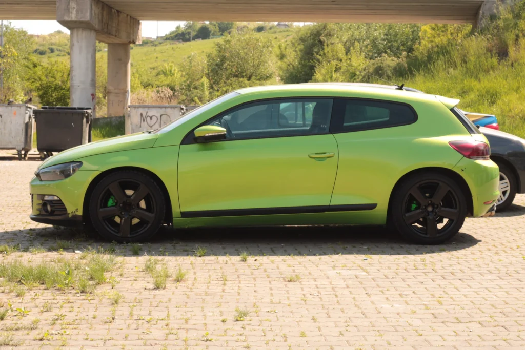 A bright green car parked in a parking lot