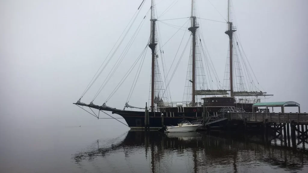A large boat floating on top of a body of water in St Marys, GA