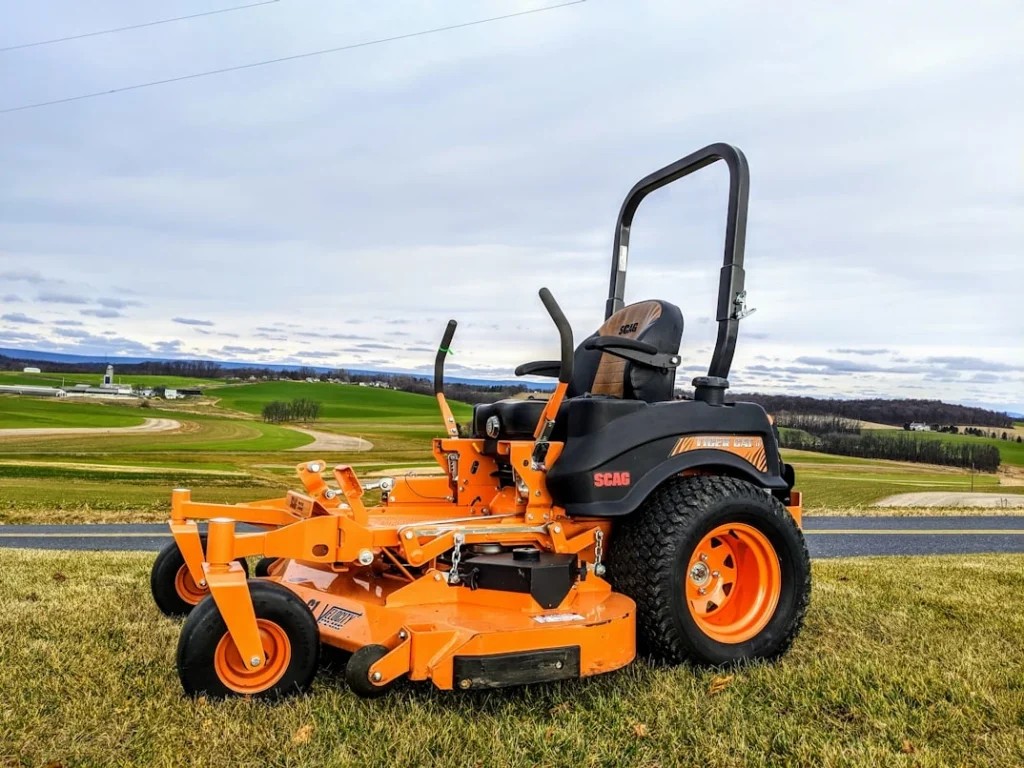 A lawn mower parked on the side of a road
