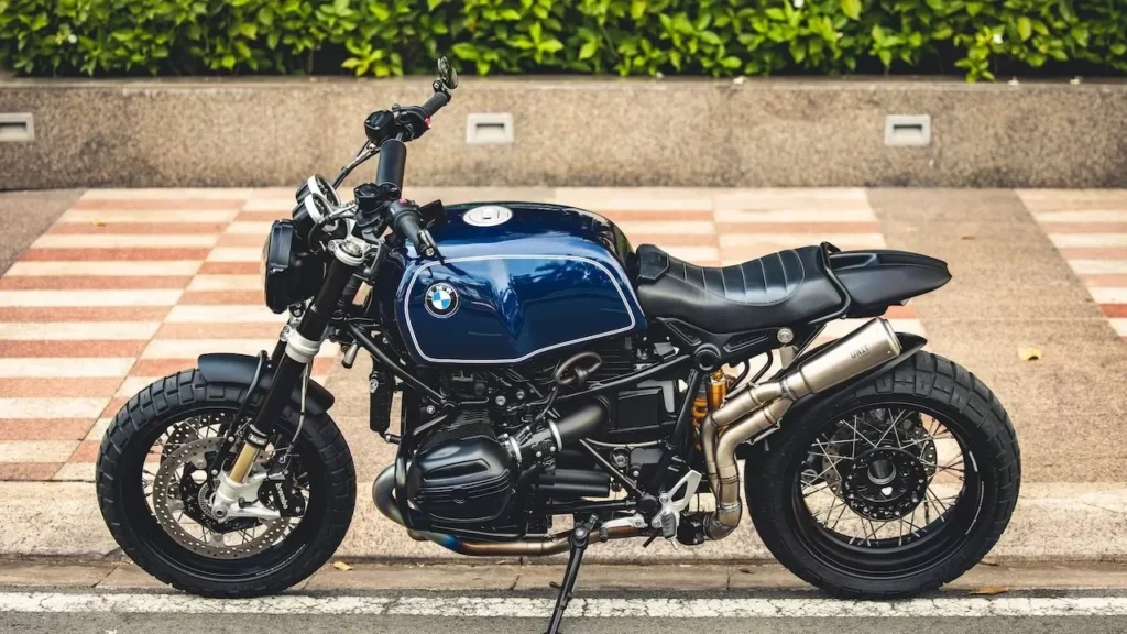 Blue BMW motorcycle parked on a city street, showcasing luxury and style