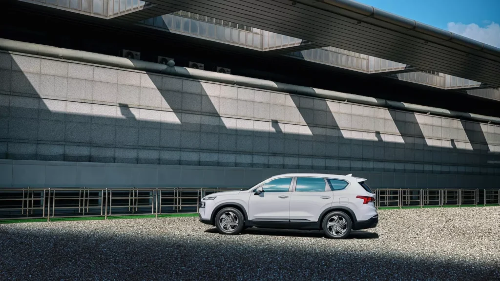 Hyundai SANTA FE in a gravel parking lot nearby the building