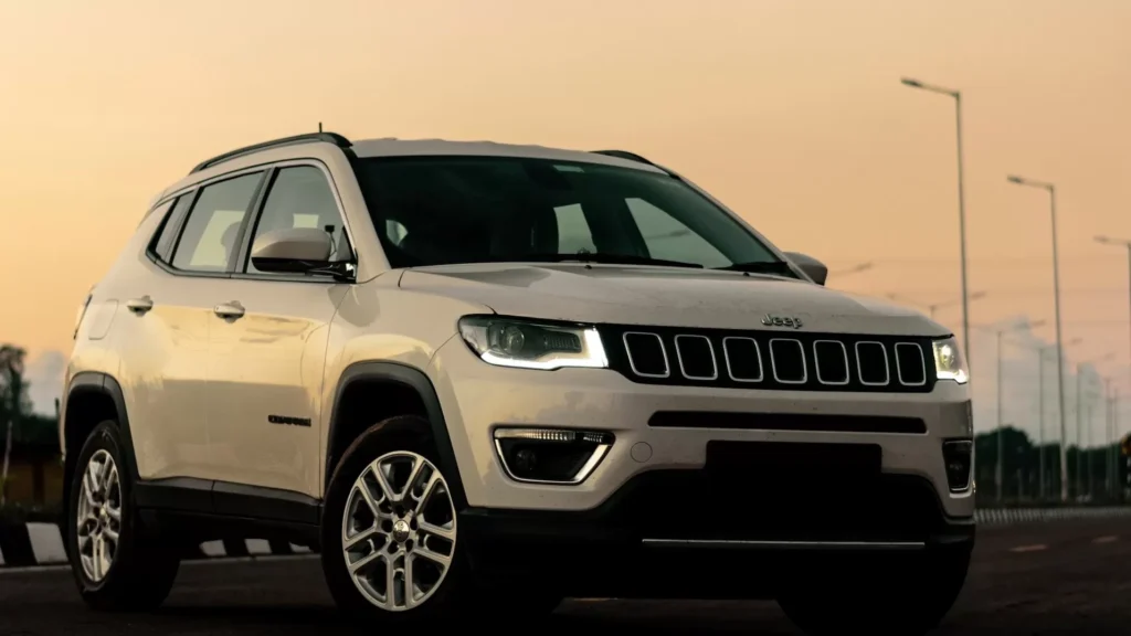 A white jeep parked on the side of a road