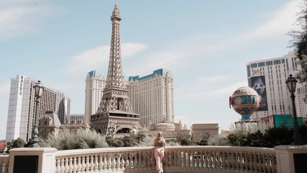 A woman standing in front of the Eiffel tower, Las Vegas, NV