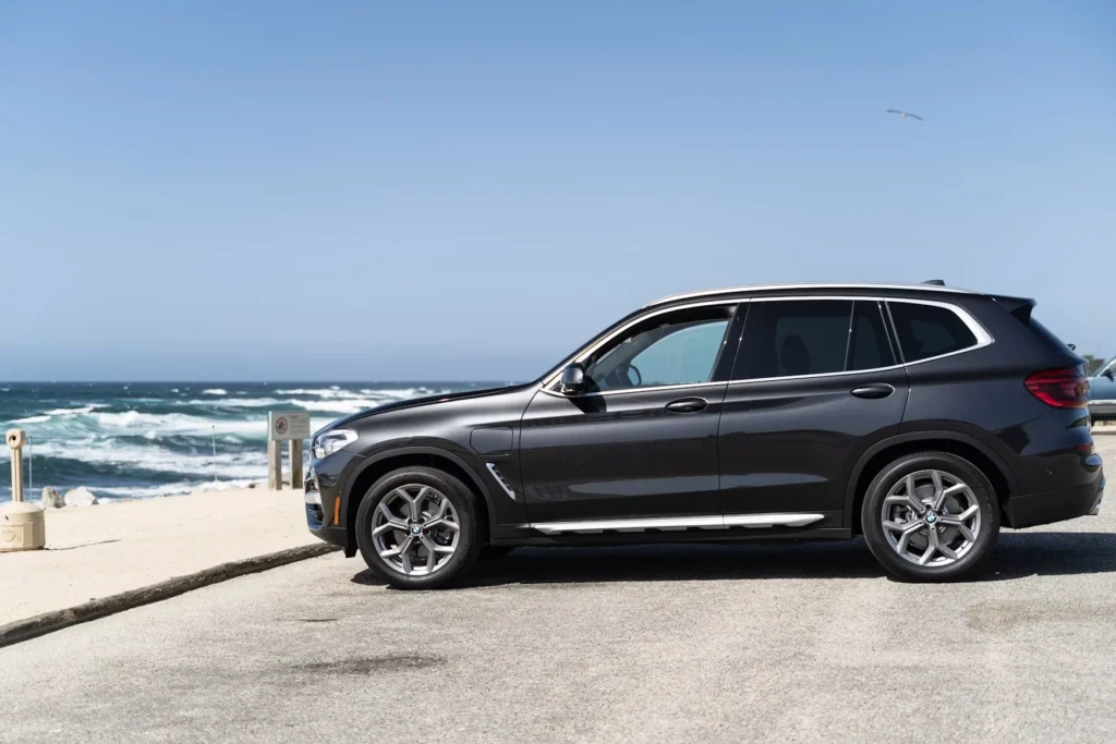 Black SUV parked on beach during daytime