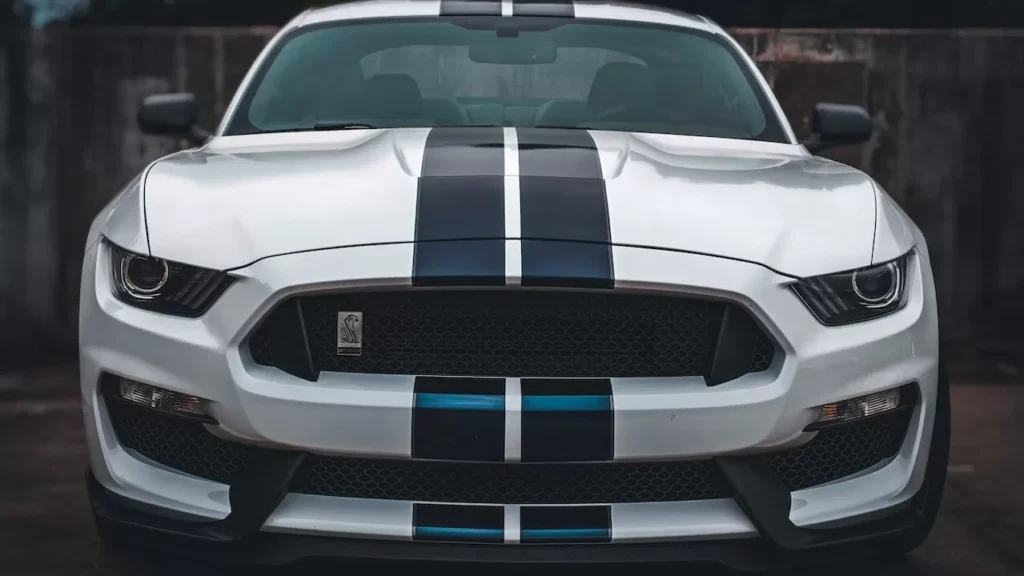 Detailed close-up of a classic Ford Mustang showcasing its front grille and iconic design