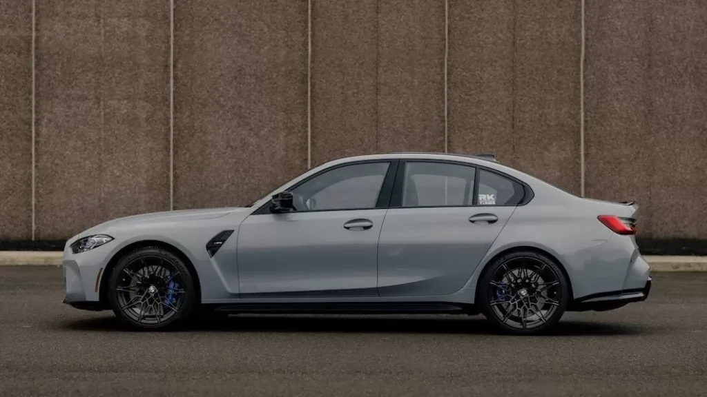 Sleek grey coupe parked by a textured wall