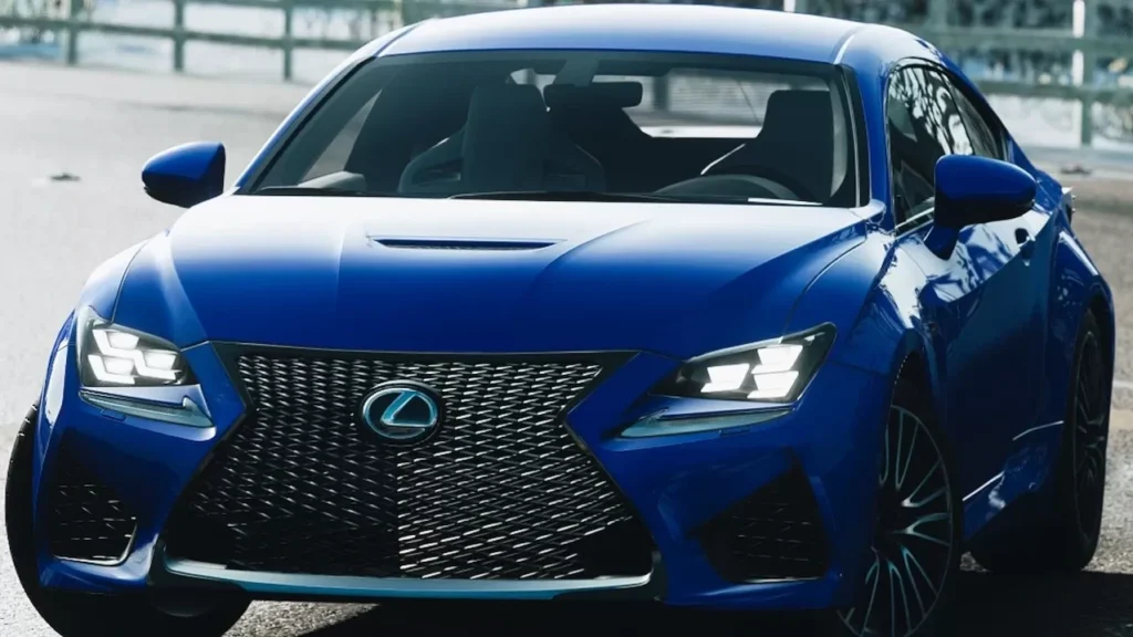 A blue Lexus sportscar parked on a scenic road, surrounded by winter trees