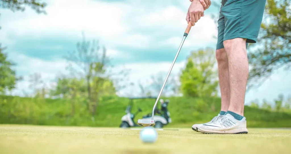 Man playing golf under blue sky during daytime