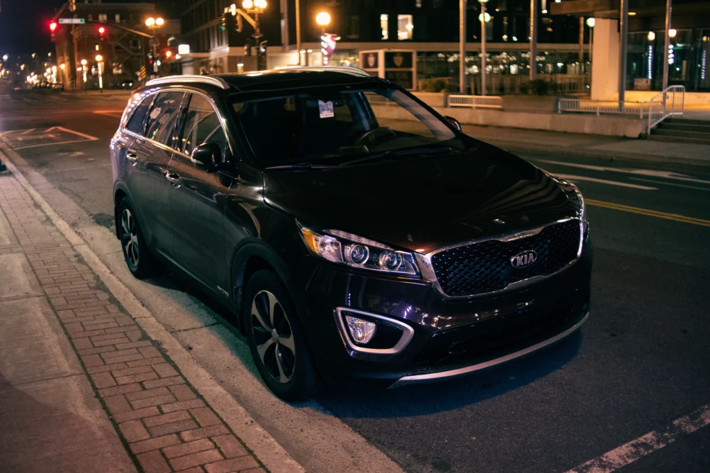 Elegant black SUV parked under city lights on a quiet urban street
