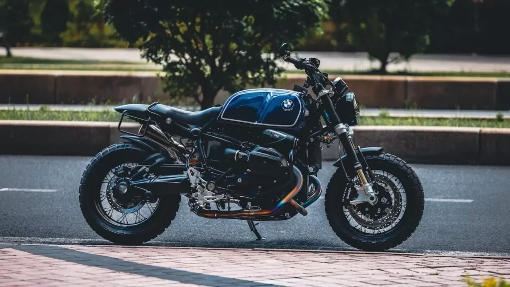 A sleek, vintage-style motorcycle is parked on a quiet city road