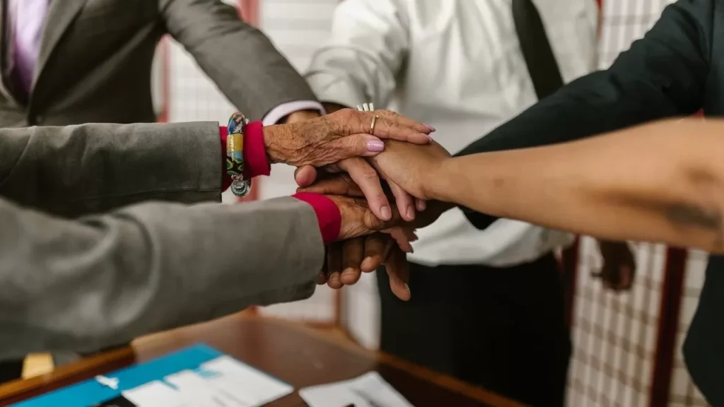 A diverse group of businesspeople uniting their hands symbolizing teamwork and cooperation