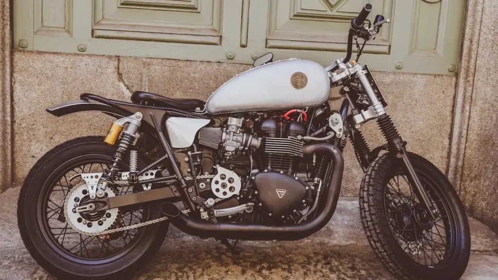 Classic motorcycle parked against a grunge wall