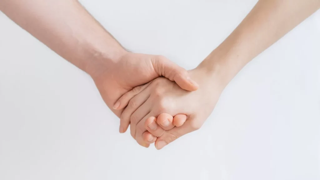 Woman and man holding hands